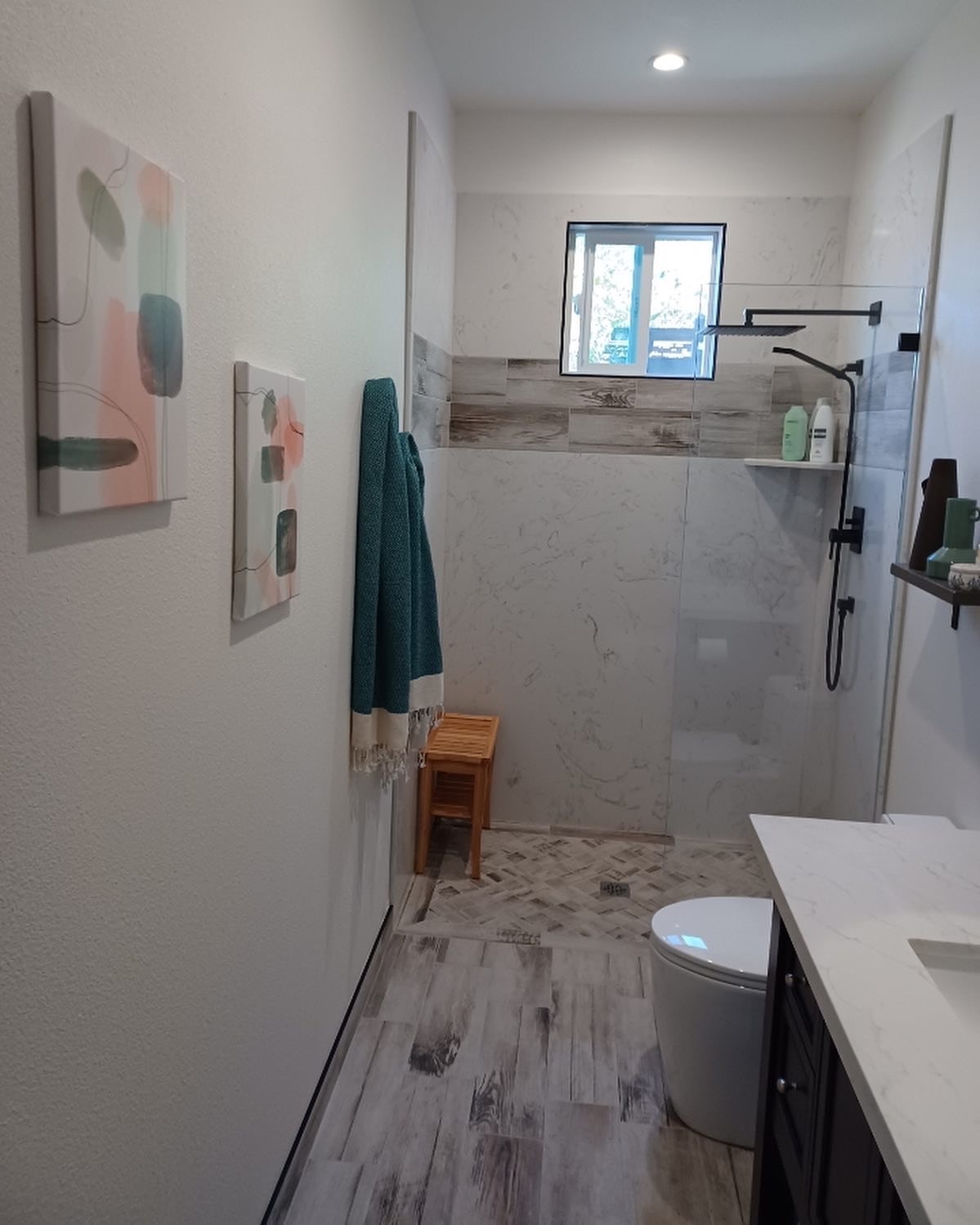 Curbless walk-in shower with quartz solid panels, glass partition, and freestanding vanity — bathroom remodel by GT Home Solution in Amador County, CA