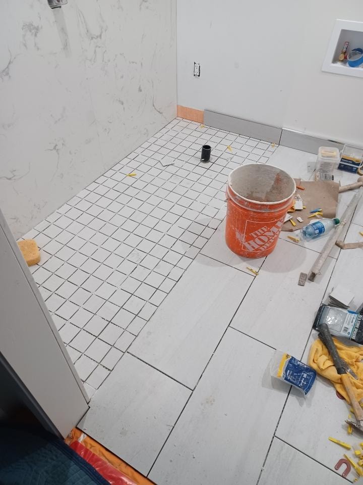 Custom bathroom tile installation in progress with tools and grout — GT Home Solution design build in Amador County, CA