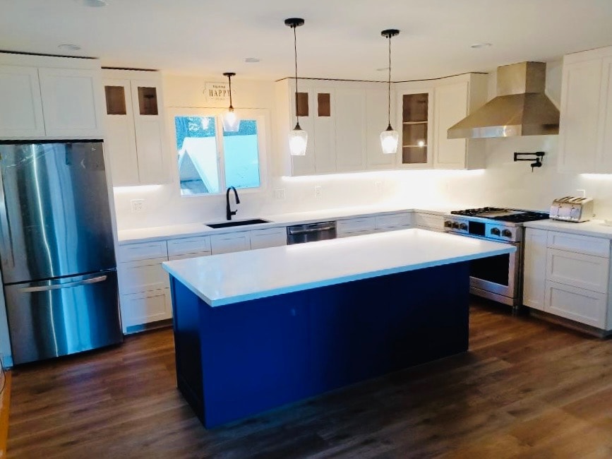 Bright kitchen remodel with custom blue island, white upper cabinets, and hardwood floors — GT Home Solution in Amador County, CA