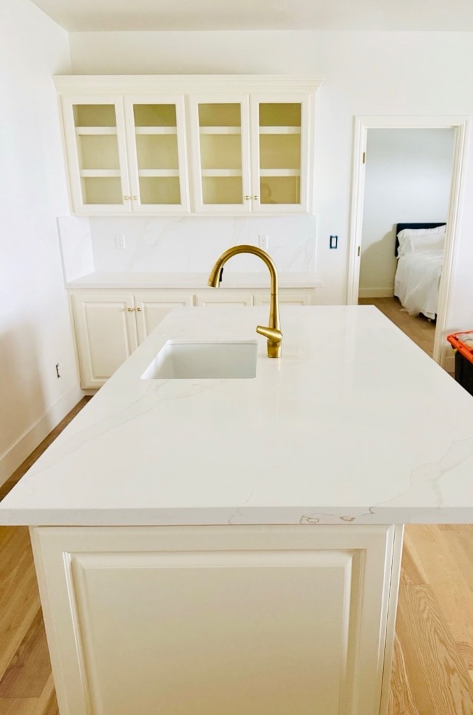 Contemporary kitchen renovation with custom island, brass faucet, and high-end cabinetry — GT Home Solution in Pioneer, CA