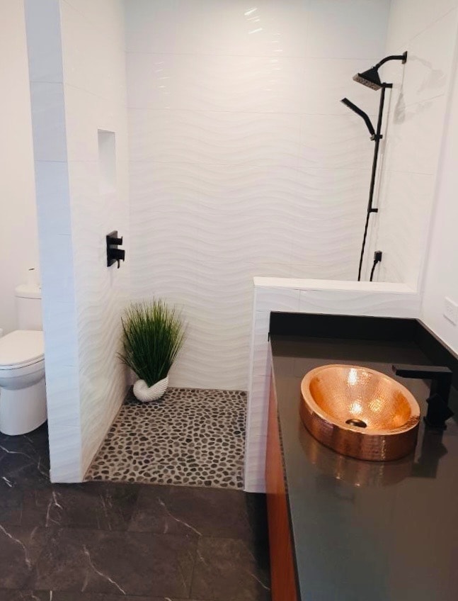 Spa-style bathroom with copper vessel sink, curbless quartz panel shower, and custom vanity — GT Home Solution renovation in Amador County, CA